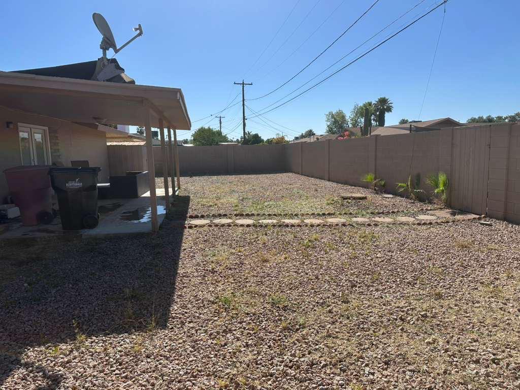 Backyard after cleanup — clean gravel with stepping stones